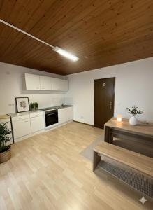 a large room with a kitchen with a wooden ceiling at Monteurzimmer Schäfer - Rhein Main in Hösbach