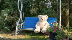 a teddy bear sitting on a blue bench at Ganghwa Picnic Pension in Incheon