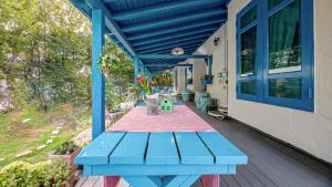 a blue bench sitting on the porch of a house at Ganghwa Picnic Pension in Incheon