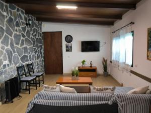 a living room with two couches and a table at Casa Chemar in La Orotava