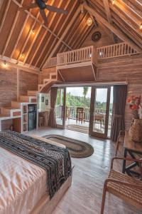 a bedroom with a bed and a wooden ceiling at Garden Terrace Bali in Gobleg
