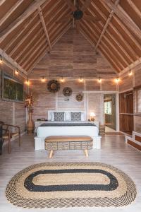 a bedroom with a large bed with a large rug at Garden Terrace Bali in Gobleg
