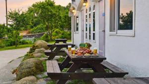 a group of picnic tables sitting outside of a building at Tongyoung Macaio Pension in Tongyeong