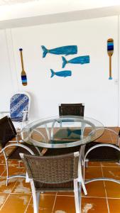a glass table and chairs in a room at Casa Tunis - poucos passos do mar in Paulista +18 photos