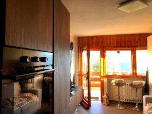 a living room with a stove and a window at Residence i Larici in Prato Nevoso