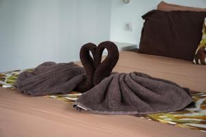 two towels on top of a bed with two hearts at EDEN Private Pool Suites and Panoramic Agung View - ADULT ONLY in Nusa Penida +62 photos