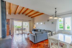 a living room with a couch and a table at Villa Betonia in Punta Prima