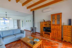 a living room with a couch and a table at Villa Betonia in Punta Prima