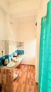 a bathroom with a sink and a shower at Serenyaa in Dibrugarh +3 photos