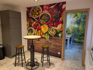 a mural on the wall of a kitchen with stools at Ferienwohnung Forest Life in Hasselfelde