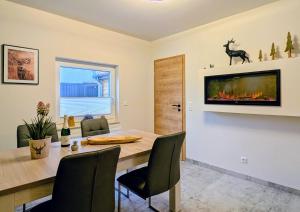 a dining room with a table and a fireplace at Ferienwohnung Forest Life in Hasselfelde