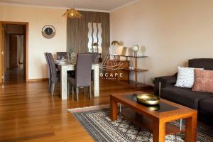 a living room with a couch and a table at Vila Sol in Prazeres