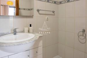 a bathroom with a sink and a shower at Vila Sol in Prazeres +30 photos
