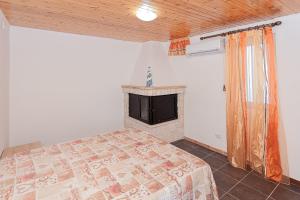 a bedroom with a bed and a fireplace at Bed and Breakfast Brezza Marina 2 in Mattinata +5 photos