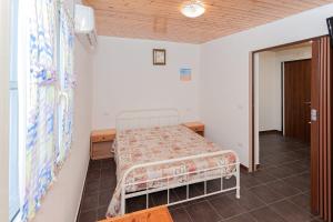 a bedroom with a bed in the corner of a room at Bed and Breakfast Brezza Marina 2 in Mattinata