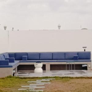 a blue couch in front of a white wall at Gulfa 9 in Sinādil