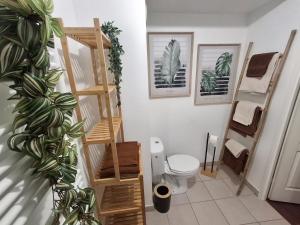 a bathroom with a toilet and some plants in it at Parenthèse lumineuse près de Disney, Parking privé in Montévrain +44 photos