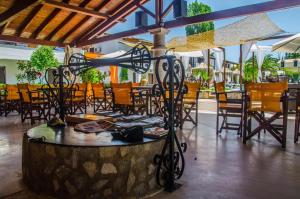 a patio with tables and chairs and a water slide at Zografia View in Corfu