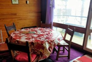 a dining room table with a red and white table cloth at Mandala in Vars