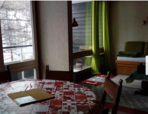 a room with a bed and a table and a window at Mandala in Vars