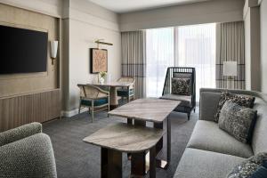 a living room with a couch and a tv at The Ritz-Carlton, Charlotte in Charlotte