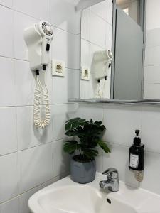 a bathroom with a phone on the wall next to a sink at Hostel POINT Nova Gorica, Self Check-In with code access in Nova Gorica +41 photos