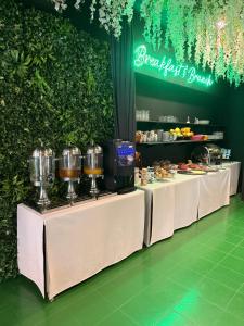 a buffet line with white tables with wine glasses at Hostel POINT Nova Gorica, Self Check-In with code access in Nova Gorica