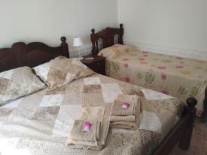 a bedroom with two beds with towels on them at JOAQUINA in Ramallo