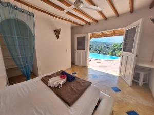 a bedroom with a bed and a view of a pool at villa vue mer - piscine privée in Las Terrenas +30 photos