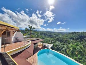 a villa with a swimming pool and a view of the jungle at villa vue mer - piscine privée in Las Terrenas