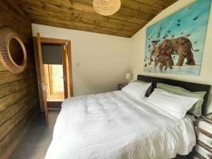 a bedroom with a large bed and a painting of elephants at Dublin Seaview Cabin in Rathfarnham