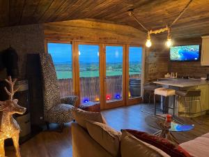 a living room with a couch and a table at Dublin Seaview Cabin in Rathfarnham
