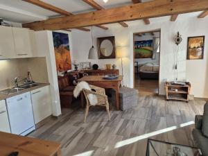 a kitchen and living room with a table and a sink at Rechenpeterhäusle in Fischerbach