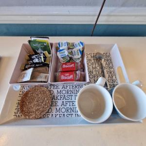 a tray with some food and cups on a table at Bayliss Hall in Weymouth