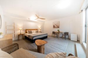 a bedroom with a bed and a living room at Tranquility Retreat in Mission Beach +43 photos