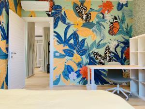 an office with a mural of butterflies on the wall at Modern 90sqm Apt - Ideal Base for Parma & Modena in Cavriago