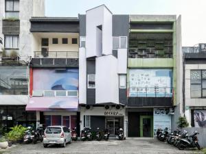 a building with motorcycles parked in front of it at Mora Stay Demangan RedPartner in Yogyakarta