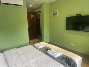 a bedroom with a bed with two towels on it at Night Sea Homestay in Jiufen