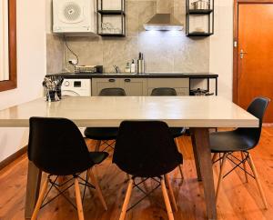 a kitchen with a large wooden table and chairs at Old Charm Guesthouse in Bass Hill
