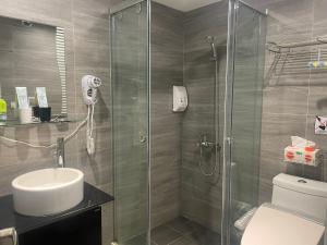 a bathroom with a shower with a toilet and a sink at Night Sea Homestay in Jiufen +21 photos