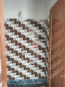 a wall of wine glasses in a wine cellar at Laxmi Narasimha Hotel in mayapur