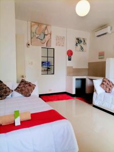 a hotel room with two beds and a desk at JULIA'S PLACE HOTEL Dangcagan - Bukidnon in Dancagan