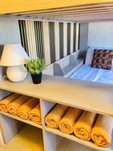 a shelf with a bed and a lamp and towels at JULIA'S PLACE HOTEL Dangcagan - Bukidnon in Dancagan