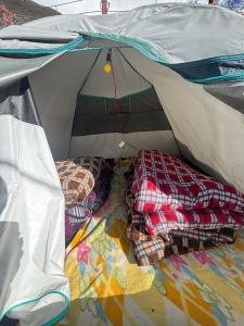 an open camping tent with two beds in it at Kedar cloud camp in Kedārnāth