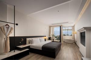 a bedroom with a bed and a tub and a television at Dali Shuanglang Erhai Lake in Dali Shuanglang +156 photos