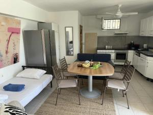 a living room with a table and a kitchen at ART BLUE Residence - Pool Access Apartment in Aghia Marina +4 photos
