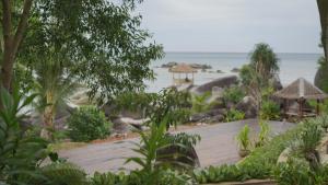 a view of a resort with the ocean in the background at Natuna Garden Villa in Ranai