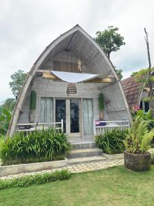 a triangular shaped house with a front entrance at Natuna Garden Villa in Ranai