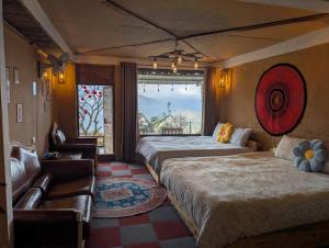 a hotel room with two beds and a window at Charming Home Tà Xùa in Bắc Yên