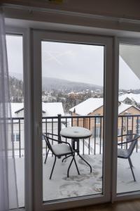 a view of a table and chairs from a window at Апартаменти Velvet Rooms in Skhidnitsa